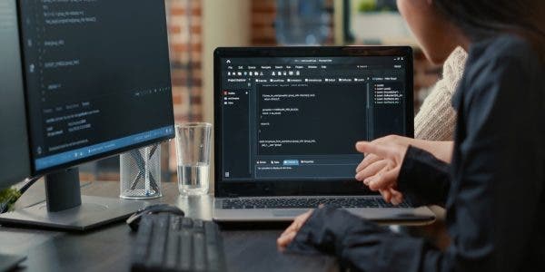 team-programmers-talking-about-algorithm-running-laptop-screen-pointing-source-code-while-sitting-desk-software-developers-collaborating-data-coding-group-project (1)